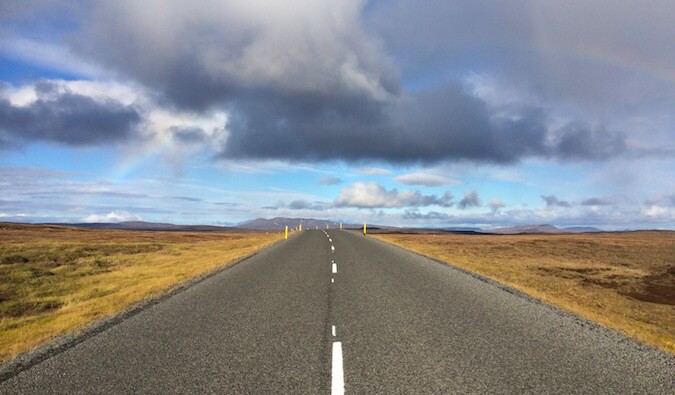 A road heading into a flat horizon in the plains