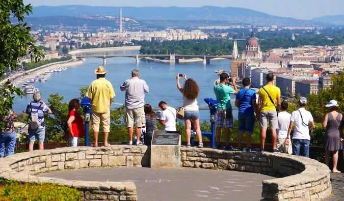 A large group of tourists taking photos of Budapest