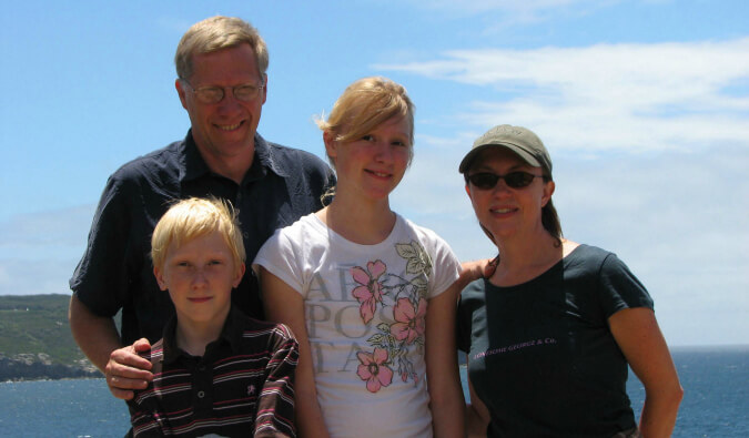 Picture of a traveling family. Mum, Dad, Son, and Daughter