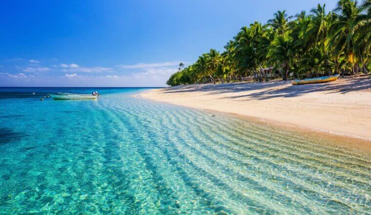 A gorgeous beach in Fiji on a sunny day with crystal clear water