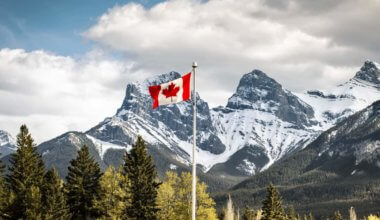 A Canadian flag waving in the mountains