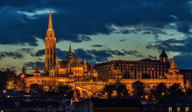 view of a church lit up at night in the city of Budapest