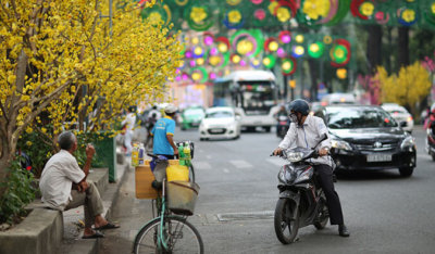 busy street scene in Vietnam. Man on a moto looking behind him at the traffic