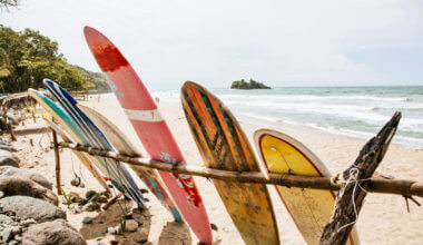 colorful surfboards resting on the beach in Costa Rica
