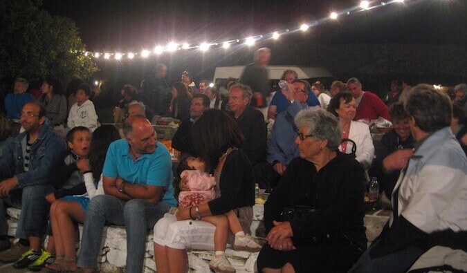 A group of people on the Greek island of Ios watching people dance