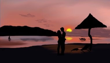 A painting of a couple on the beach at sunset