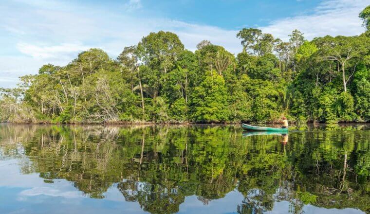 A lone canoe on the river in the Amazon jungle in Bolivia