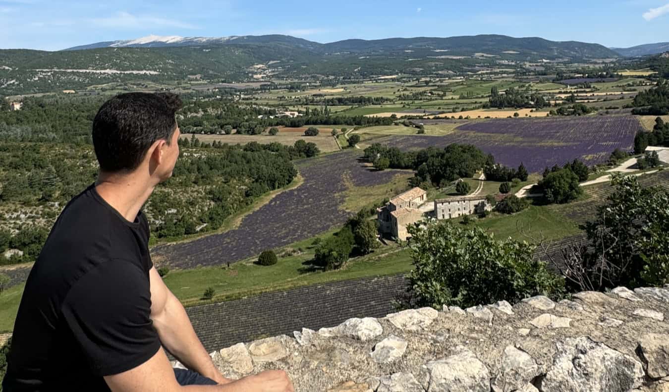 Nomadic Matt looking out over the landscape in beautiful France during the summer