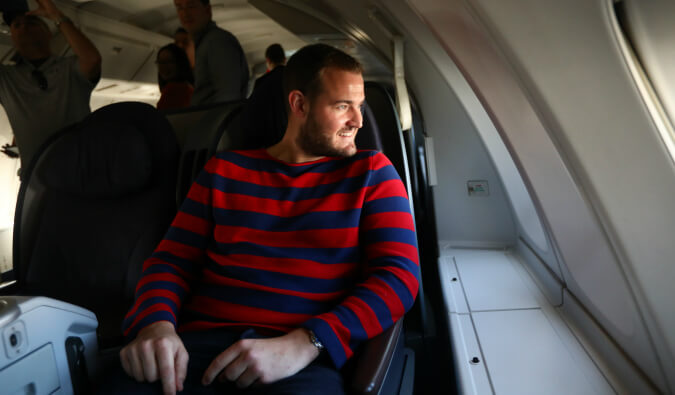 Man sat on airplane looking out the window