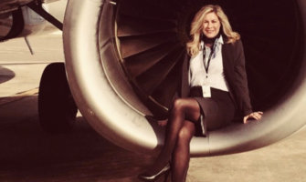 Flight attendant Heather Poole posing by an airplane