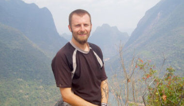 dan slater posing for a photo while traveling the world