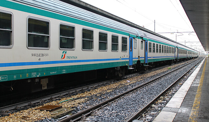 European train on the tracks at a train station