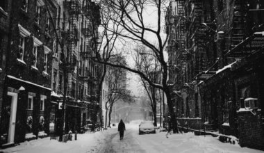 Black and white photo of someone walking in the snow in NYC
