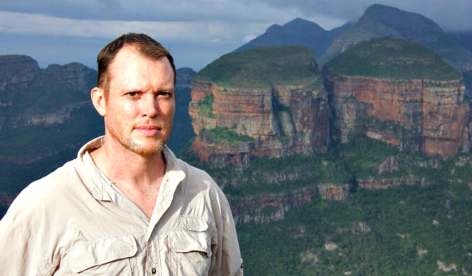 Rolf Potts pictured front left with mountains in the background