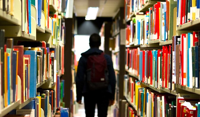 A guy working through a library