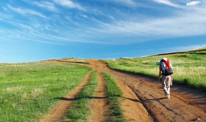 A backpacker walking in the field