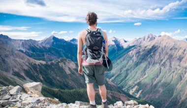 Man looking over a canyon on a sunny day