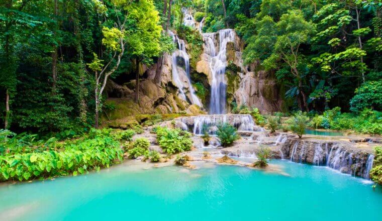 The picturesque Kuang Si waterfall surrounded by jungle in Laos, Southeast Asia