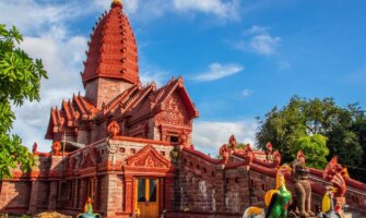 the bright red and ornately decorated Temple Wat Phrai Phatthana in Isaan, Thailand