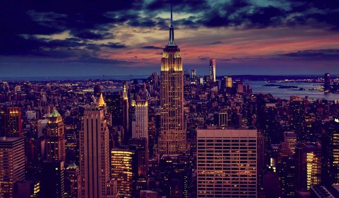 New York City at night central to the image is the Empire State Building