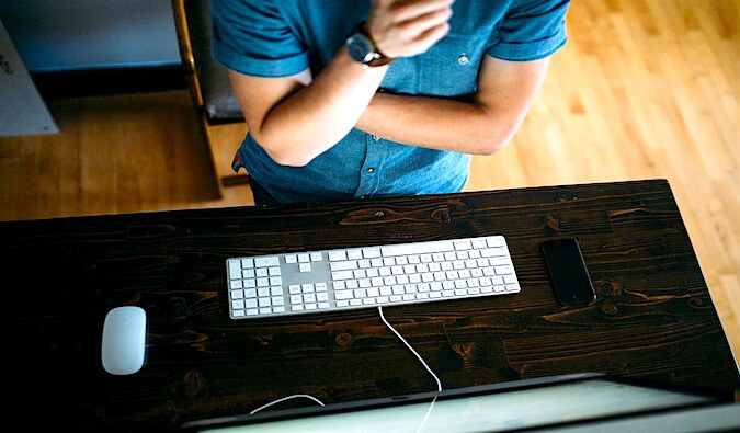 a man looking at his laptop keyboard