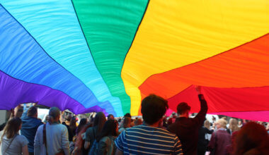 A huge rainbow flag at a gay pride parade