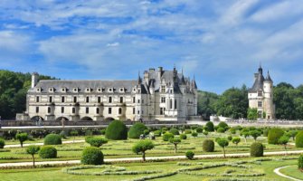 A chateaux in France and the surrounding gardens on a beautiful summer day