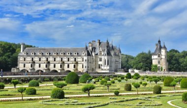A chateaux in France and the surrounding gardens on a beautiful summer day