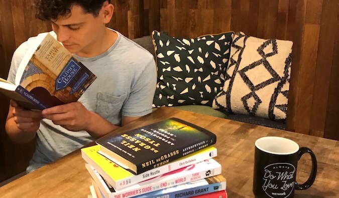 Nomadic Matt reading books in wework