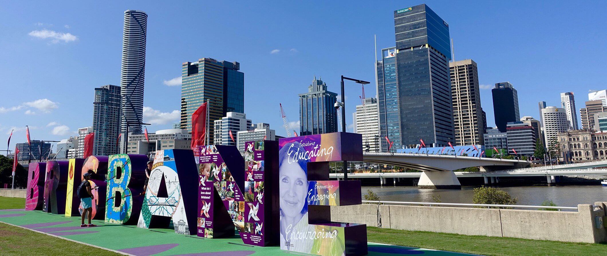 the colorful large Brisbane sign in Brisbane Australia in the foreground. the tall buildings of the city in the background