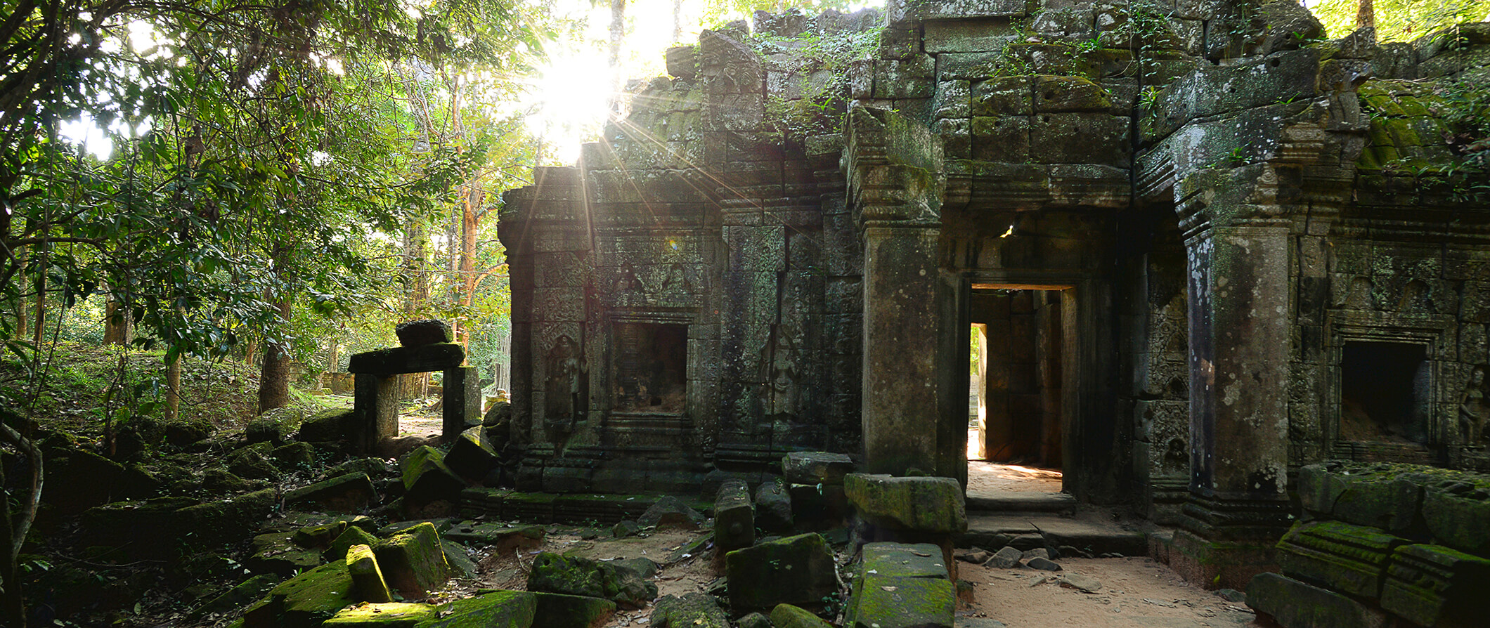 a crumbling temple in Siem Reap, Cambodia with the sun shining through
