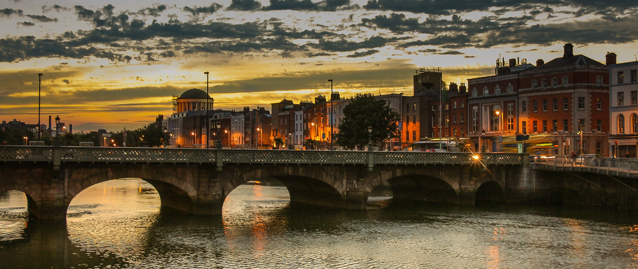 Dublin looking across the bridge with the city in the background at dusk