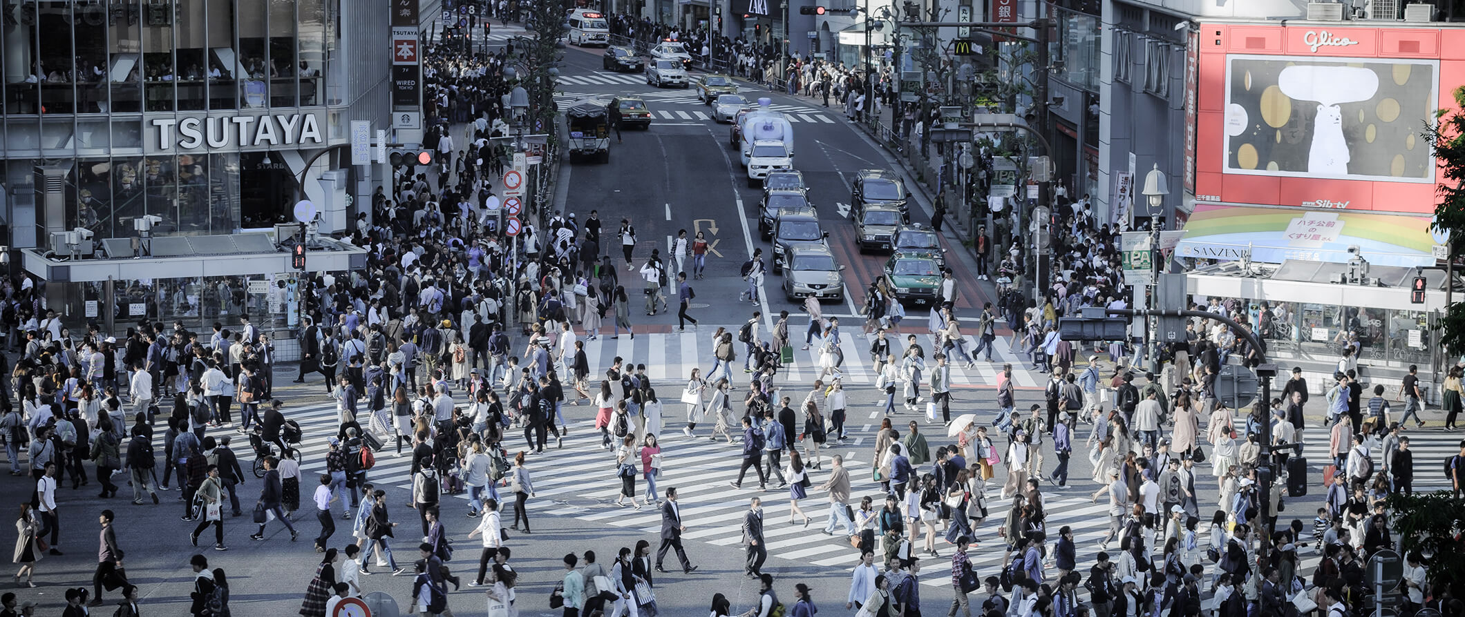 People walking on a busy intersection in Tokyo