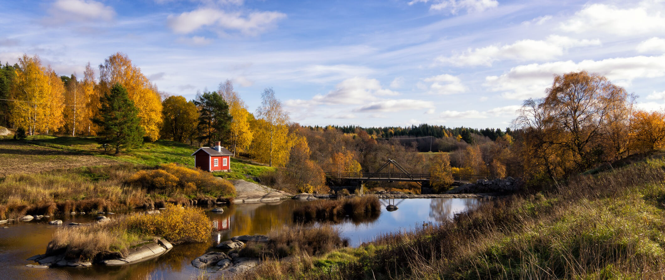 Small loan house on the bank of a river surrounded by nature in Finland