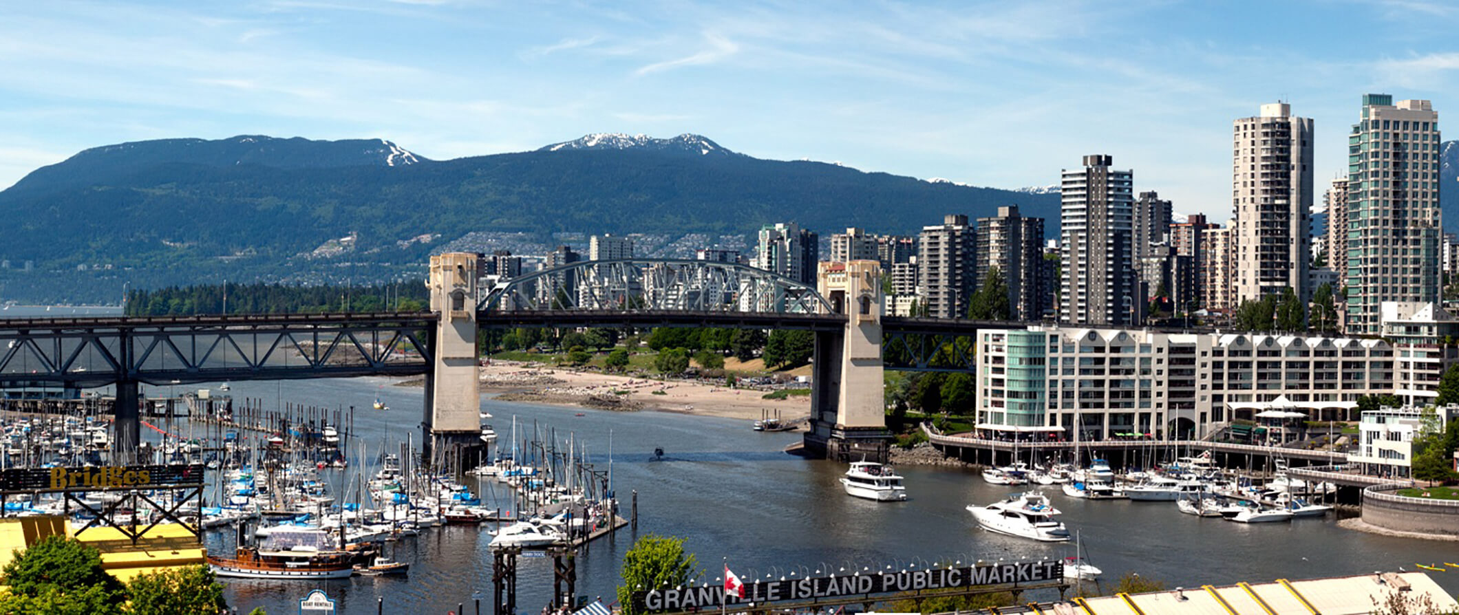 city view of Vancover looking out over a river with a bridge across