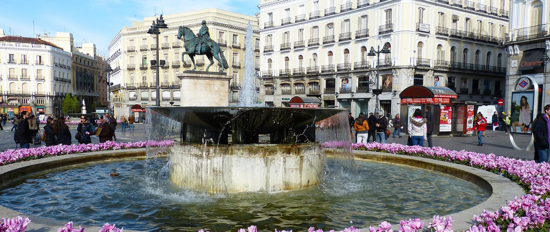 Fountain in central Madrid surrounded by flowers