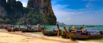 Iconic Thai longboats ties up on a beach in Thailand