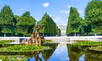 A calm fountain reflecting the trees near a palace in Vienna, Austria