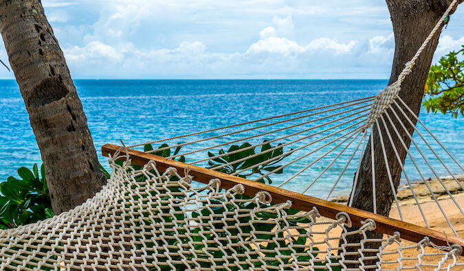 hammock on the beach sand and blue sea