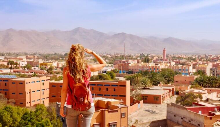 A solo female traveler looking out over a city in Morocco