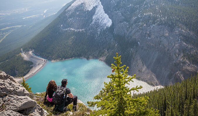 a man and woman looking out at a lake in Canmore, Alberta