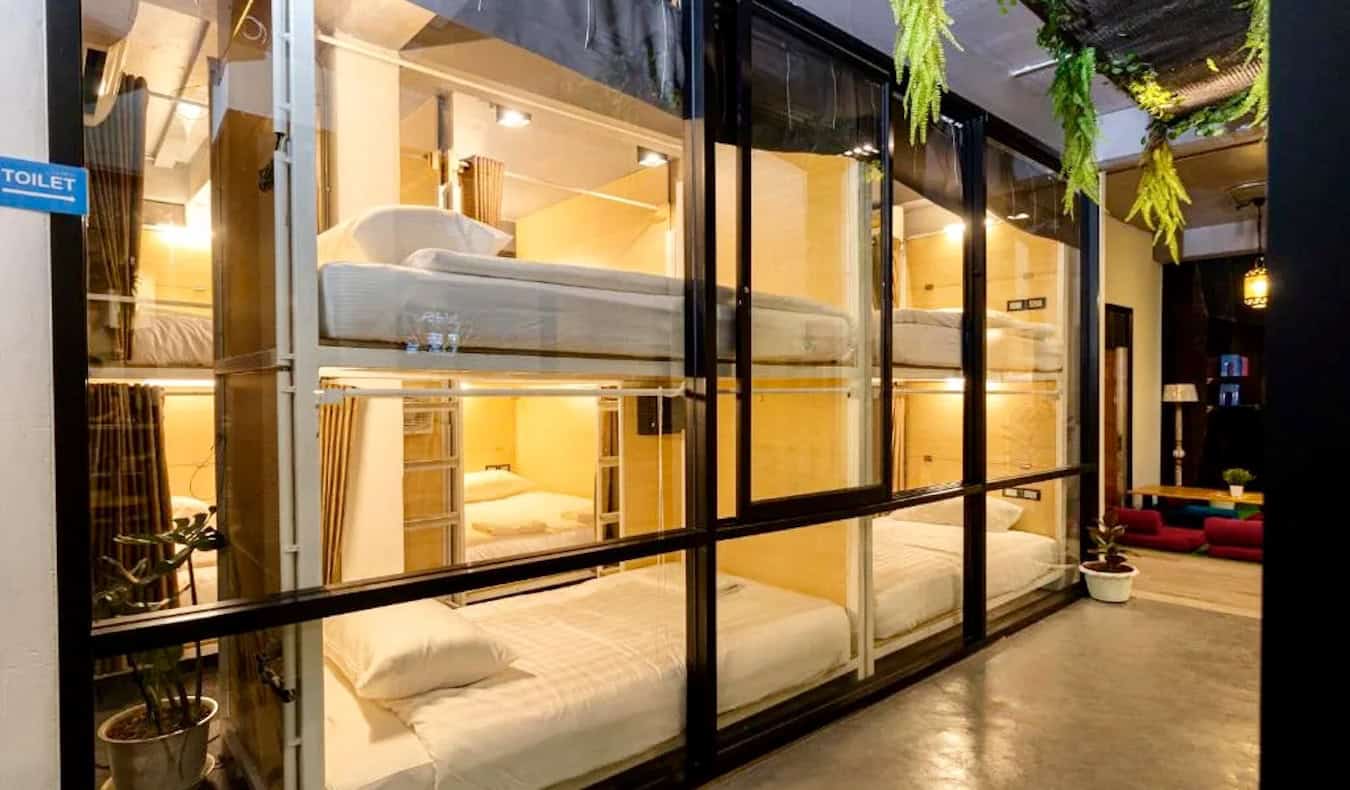 Window looking into cozy capsule beds at the Khao San Social Capsule Hostel in Bangkok