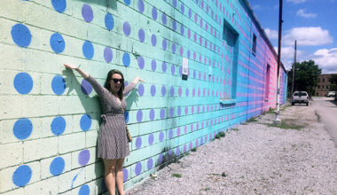 Caroline Eubanks standing in front of murals in Chattanooga, Tennessee