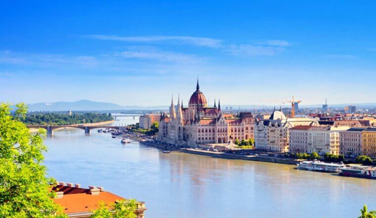 The historic and massive parliament building along the Danube in sunny Budapest, Hungary