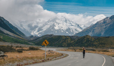 Kristin Addis standing on a empty winding road in the mountains