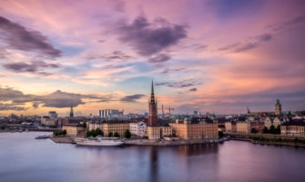 A long-exposure shot of Stockholm during the sunset with a purple sky