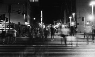 black and white photo of a busy crosswalk with blurred people