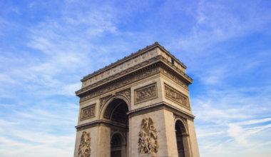 The Arc de Triomphe against a bright blue sky in Paris, France