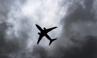 A commercial airplane flying in a dark sky
