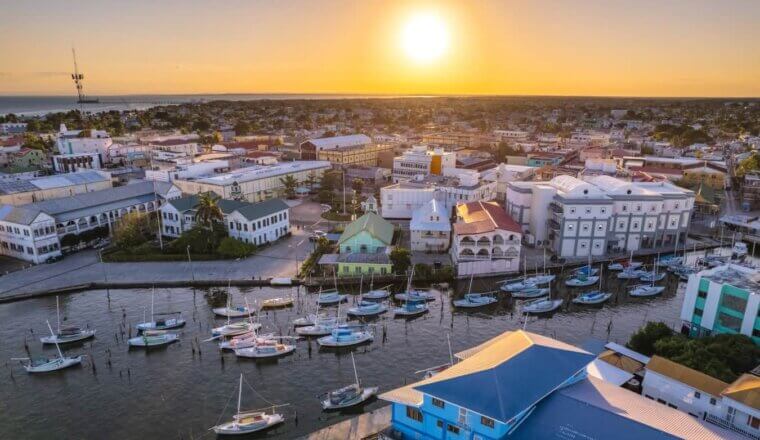 Aerial photo of the river mouth area filled with boats near downtown Belize City